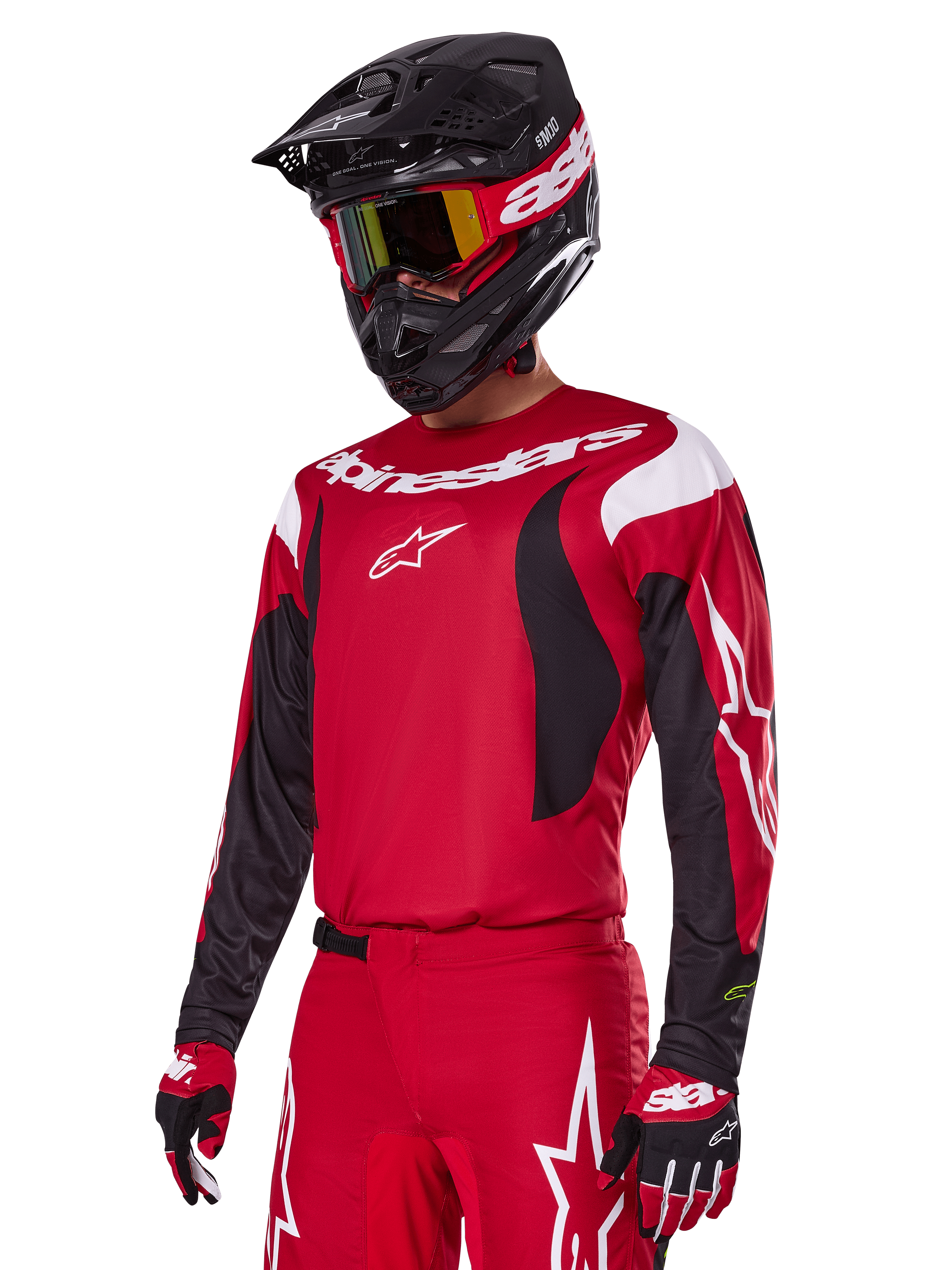 Motocross rider wearing Alpinestars 2025 Fluid Haul Gear Set in Red, featuring a red jersey with white and black accents, matching red pants with white graphics, black helmet with white branding, red and yellow goggles, and red and black gloves, coordinated motocross racing outfit