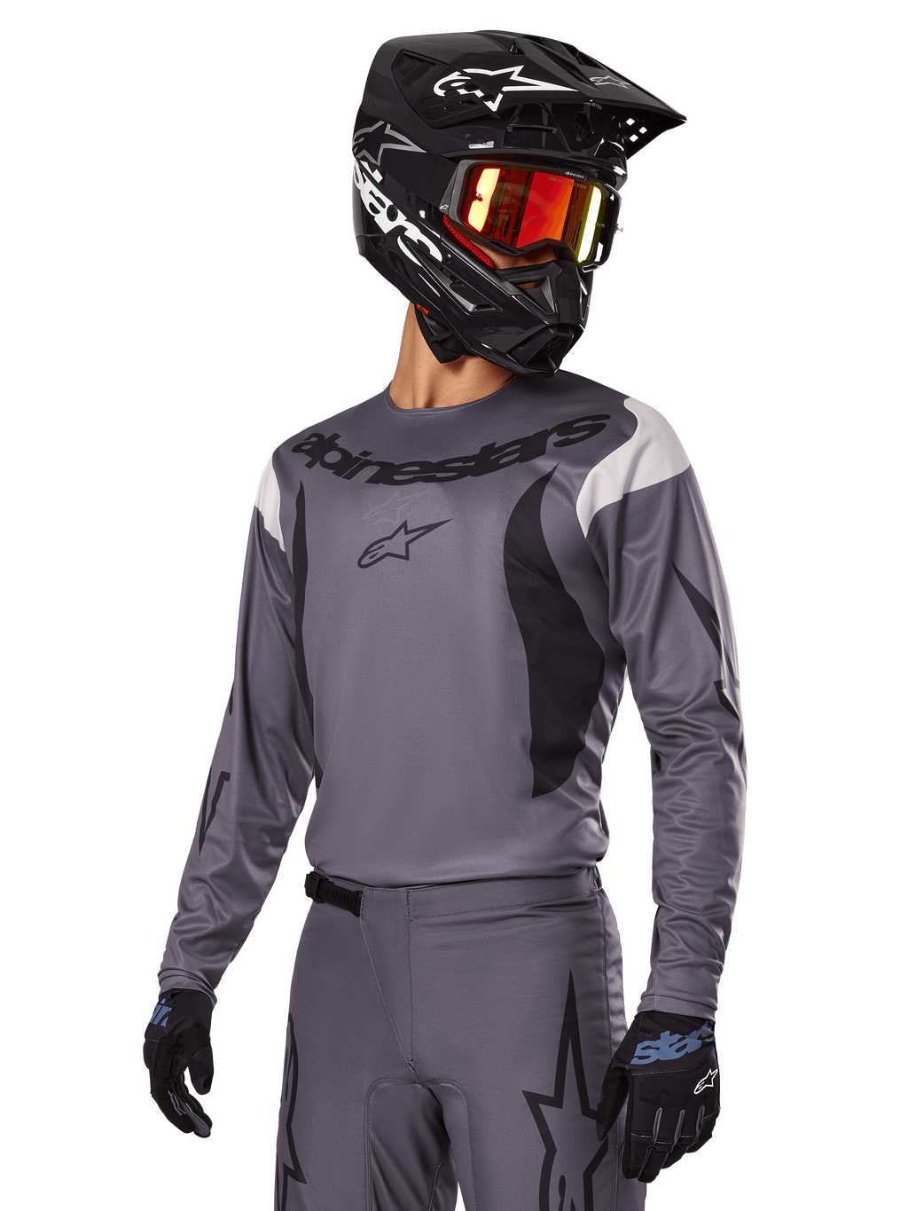 Alpinestars 2025 Fluid Haul Gear Set, Gray Motocross Jersey and Pants, featuring black and white accents, worn with a black helmet, red goggles, and black gloves, athletic sport fit for off-road riding