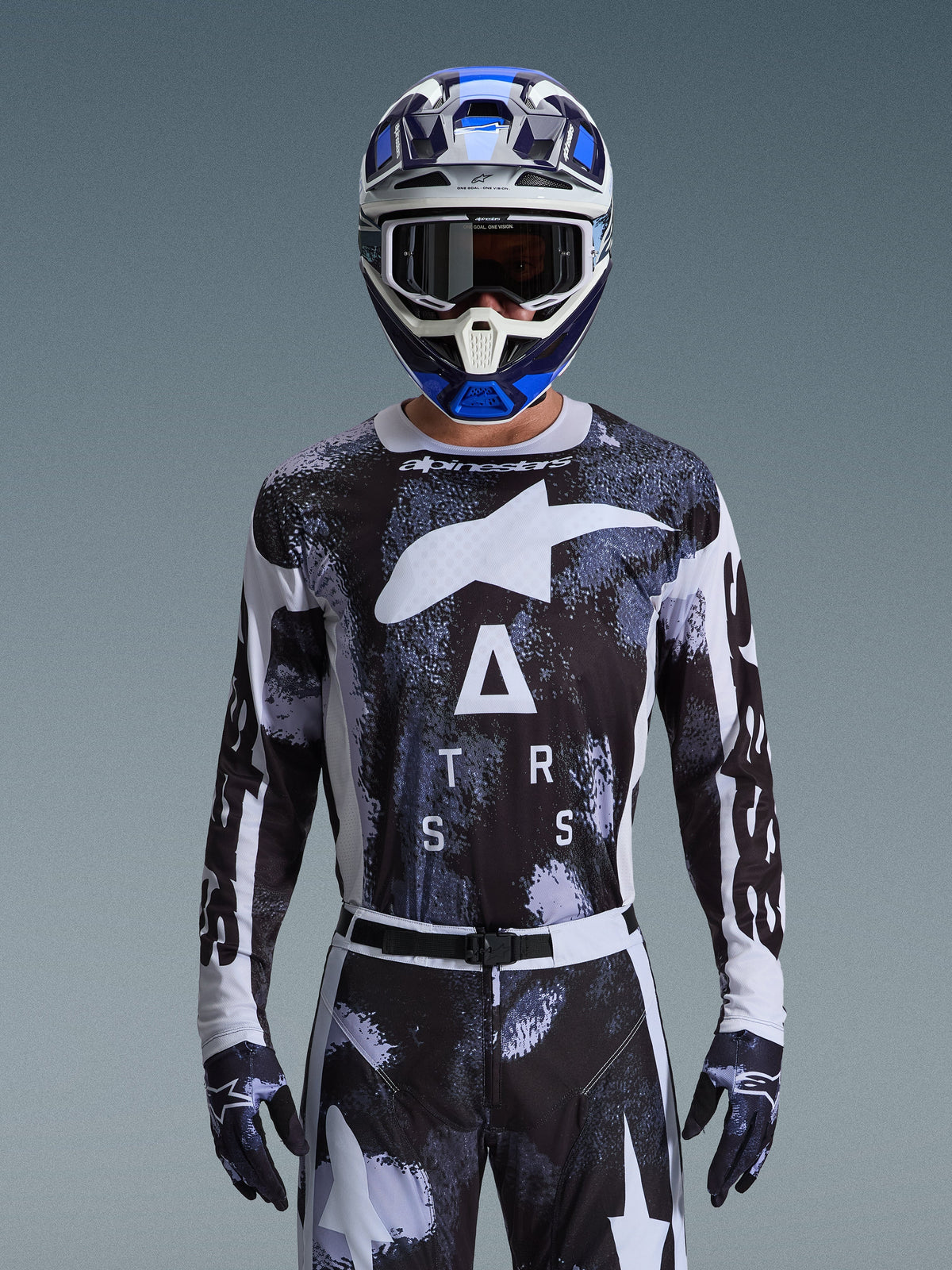 Alpinestars 2026 Racer Lahnd Jersey, Motocross Gear, Iron Camo pattern in Black and White, featuring a bold Star logo and ASTARS lettering, worn with matching pants and a blue motocross helmet