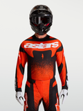 Alpinestars Techstar Swan Jersey, Cardinal Red and Black motocross jersey with performance fit on model.