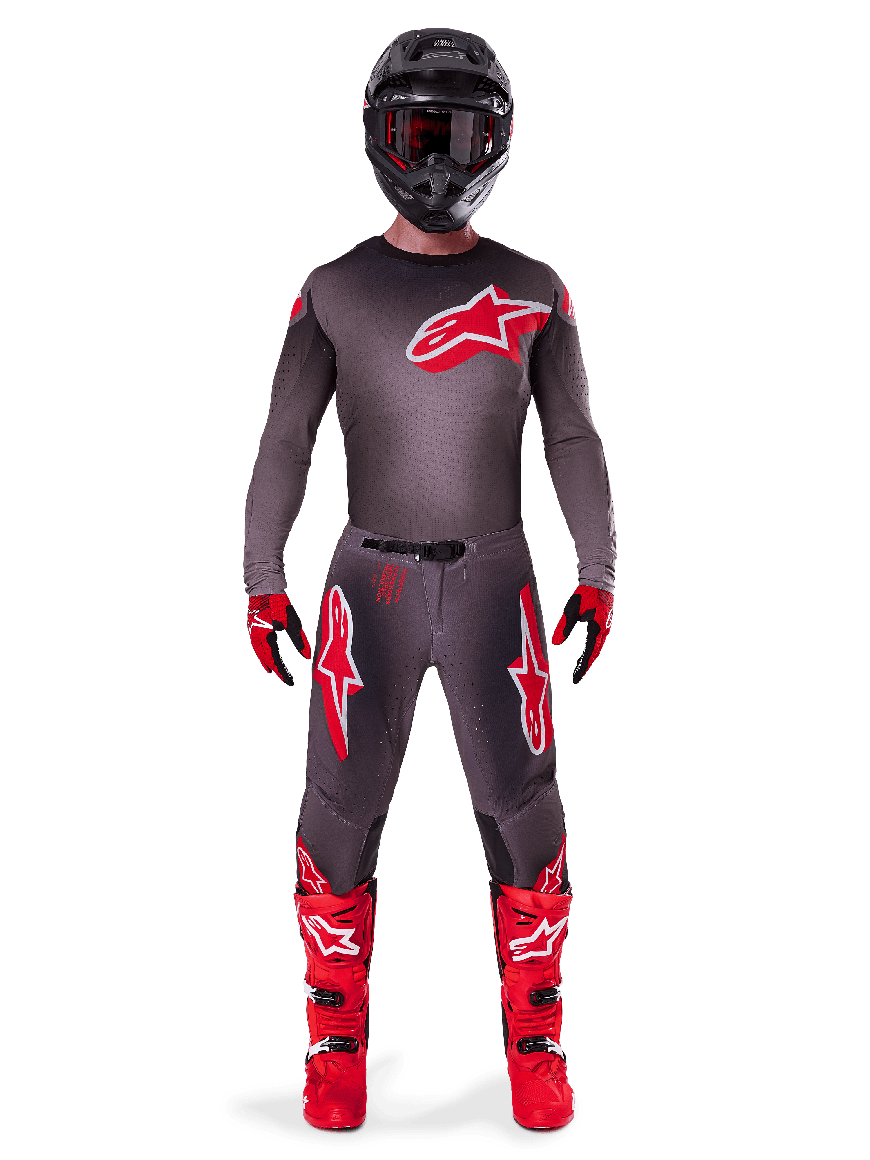 Motocross rider wearing Alpinestars 2025 Supertech Lipan Gear Set, Smoke and Bright Red, dark grey jersey and pants with bold red Alpinestars logos, bright red boots, black helmet, and red gloves, coordinated professional outfit for off-road racing