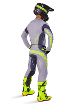 Alpinestars 2025 Techstar Dreem Jersey, Motocross Jersey, Gray and Dark Gray, worn with matching pants and bright neon yellow boots, back view showing neon yellow branding and athletic fit for off-road racing