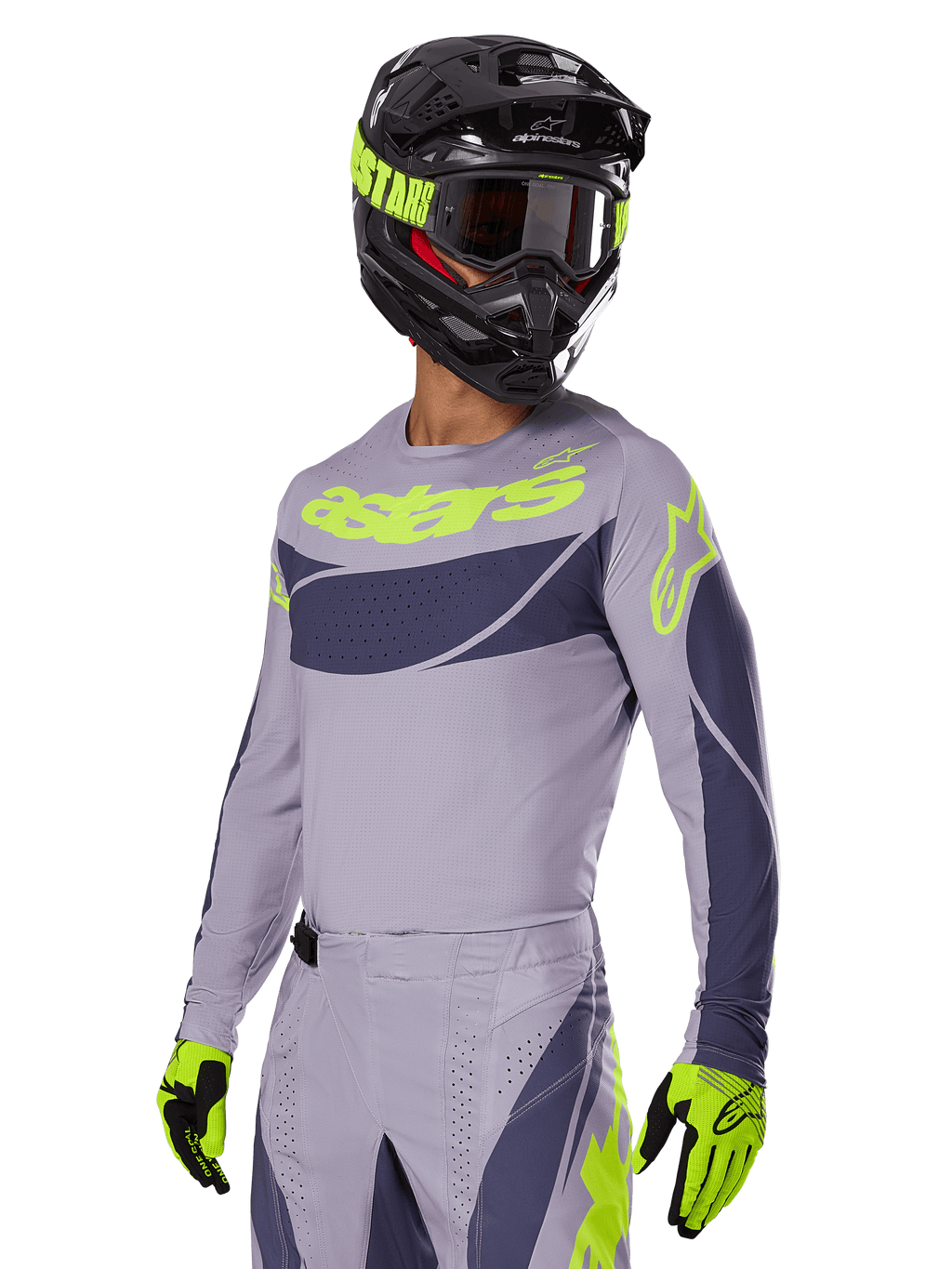 Motocross rider wearing the Alpinestars 2025 Techstar Dreem Jersey in Gray and Dark Gray, featuring a neon yellow 'astars' logo on the chest, paired with a matching helmet, goggles, and gloves for a coordinated off-road racing look
