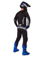 Motocross rider from a rear view wearing the Alpinestars 2025 Racer Graphite Gear Set, Black and Gray jersey and pants with gray branding, paired with bright blue motocross boots, a black and blue helmet, and blue gloves, complete performance off-road outfit.