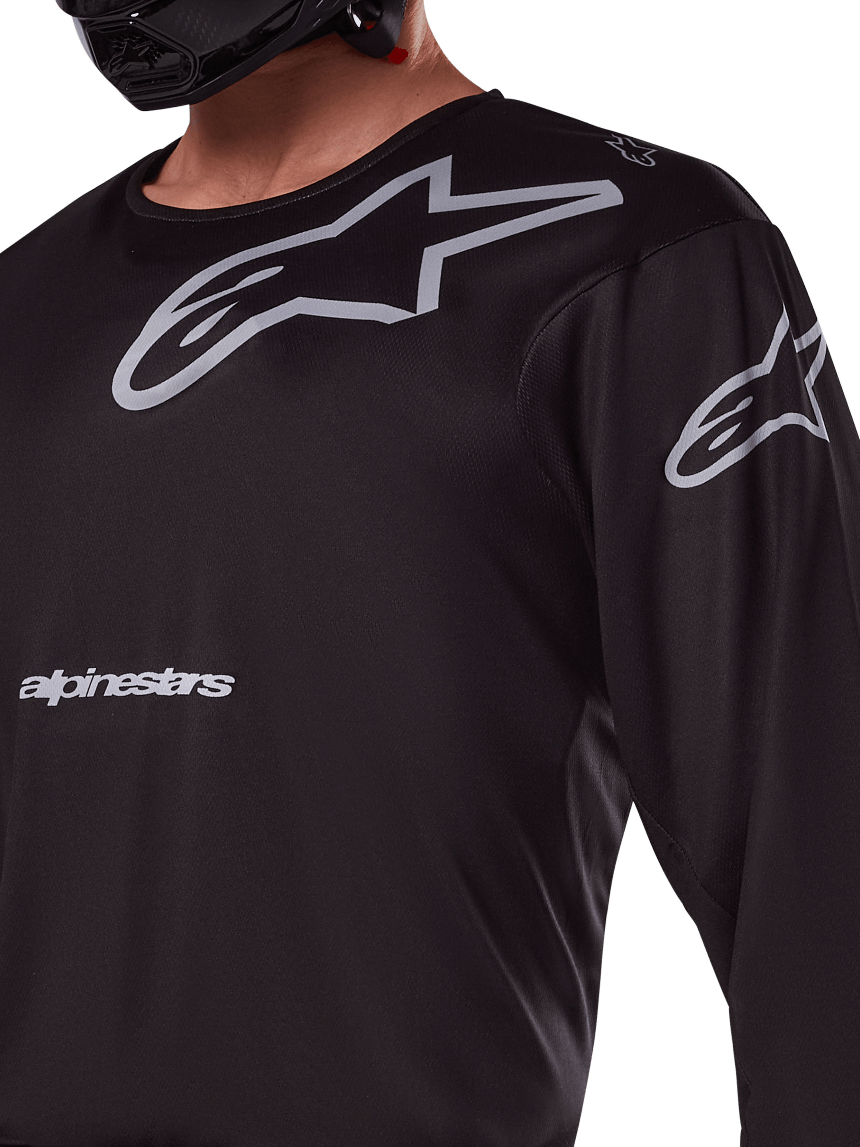 Alpinestars 2025 Racer Graphite Jersey, Black and Gray, close-up of rider wearing motocross jersey, featuring grey Alpinestars branding and A-star logos, technical poly-fabric material for off-road riding