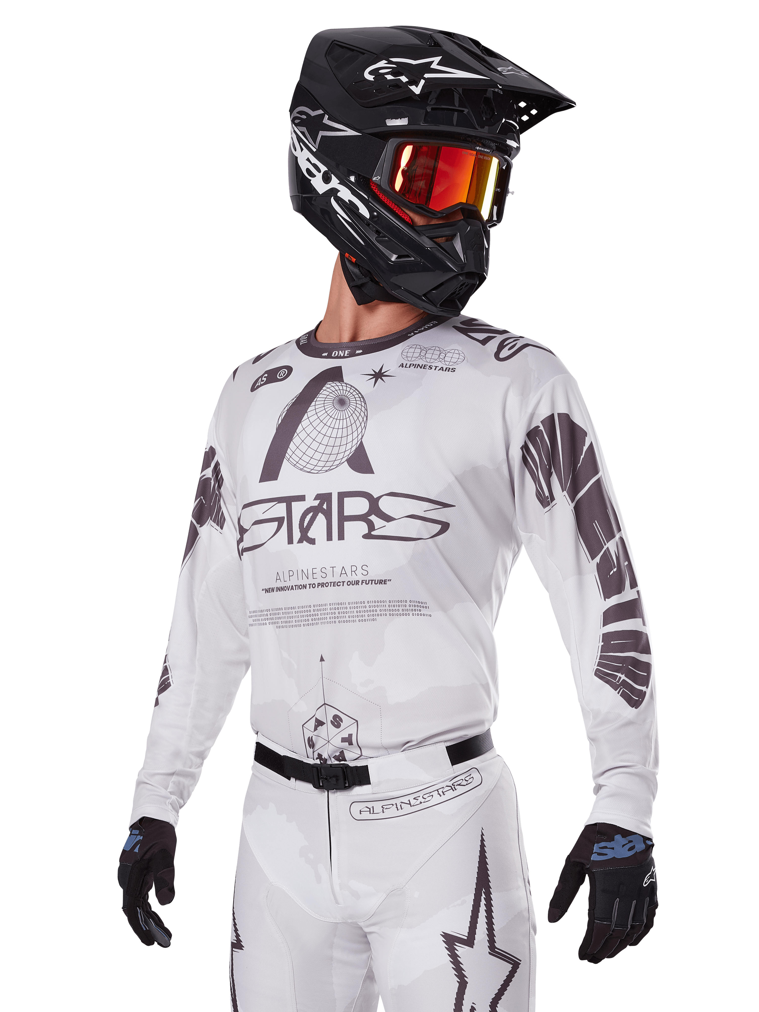 Alpinestars 2025 Racer Hollow Gear Set, Motocross Jersey and Pants, White with black and grey graphics, featuring 'ASTARS' branding and hollow globe designs, worn with a black helmet, red mirrored goggles, and black gloves, designed for off-road performance