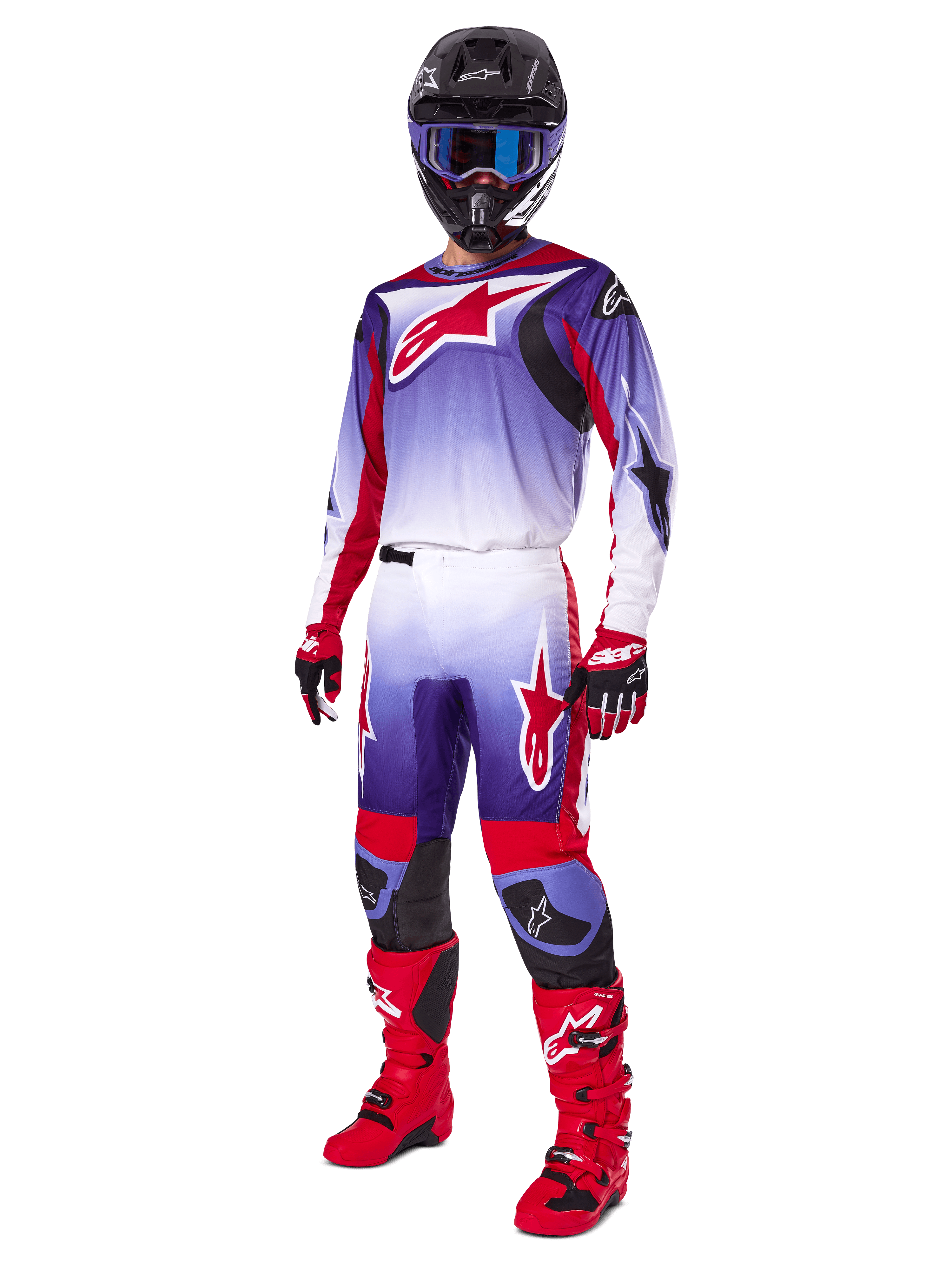 Motocross rider wearing the Alpinestars 2025 Fluid Wurx Gear Set, purple and bright red jersey with white accents, matching motocross pants, bright red boots, black helmet with blue goggles, and red and black gloves, full professional off-road racing kit