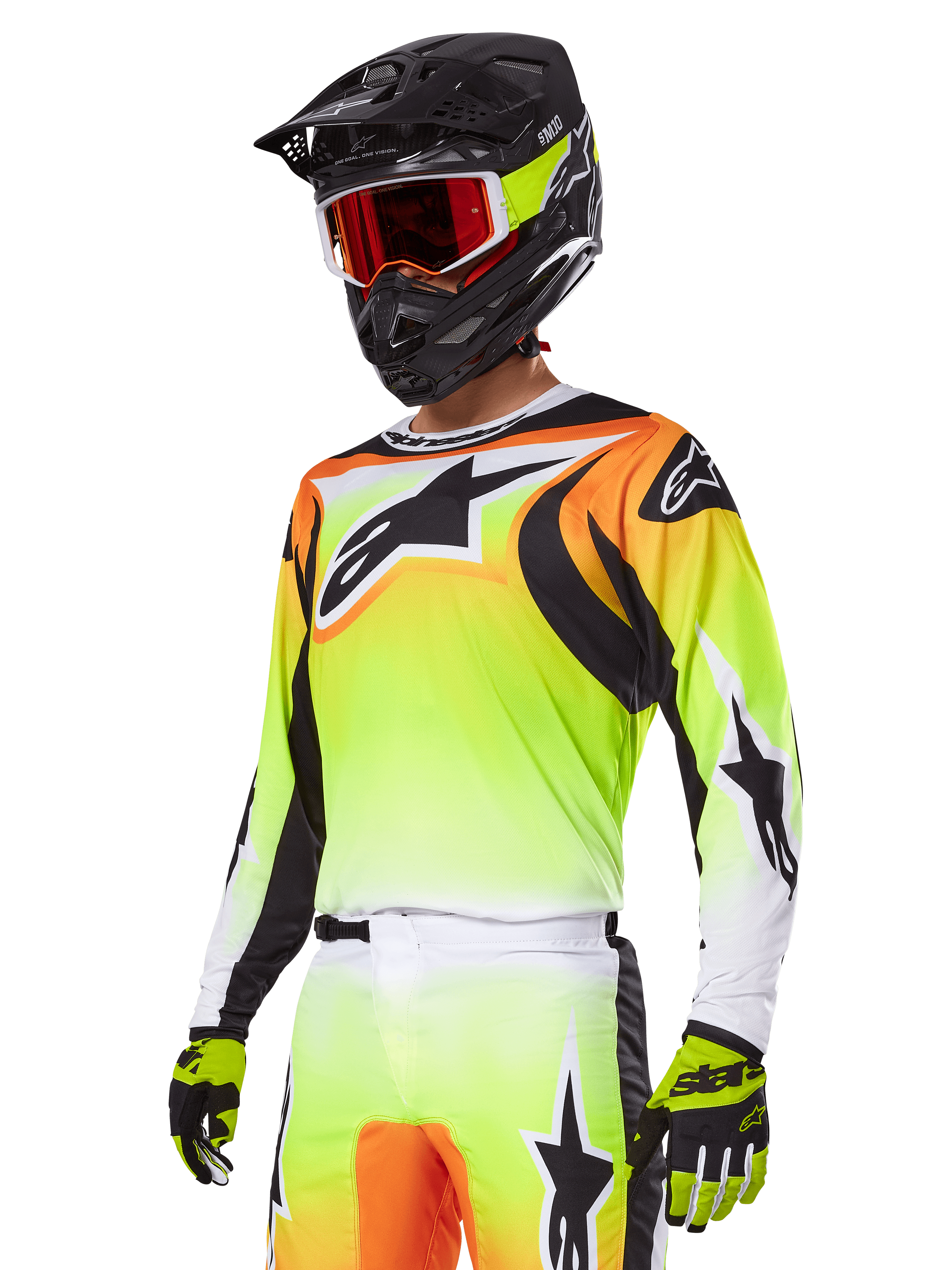 Motocross rider wearing Alpinestars 2025 Fluid Wurx Gear Set, Yellow and Orange gradient jersey with black accents and large star logos, matching motocross pants, black full-face helmet with red-tinted goggles, and yellow gloves, coordinated high-performance outfit for off-road racing