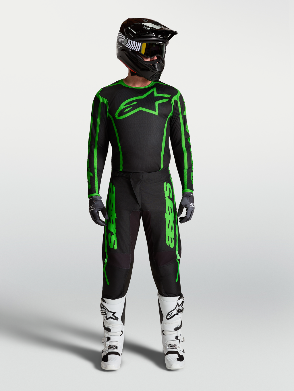 Alpinestars Fluid Apex V2 Pants, Men's Motocross Gear, Black and Green Fluo, full racing outfit with white boots.