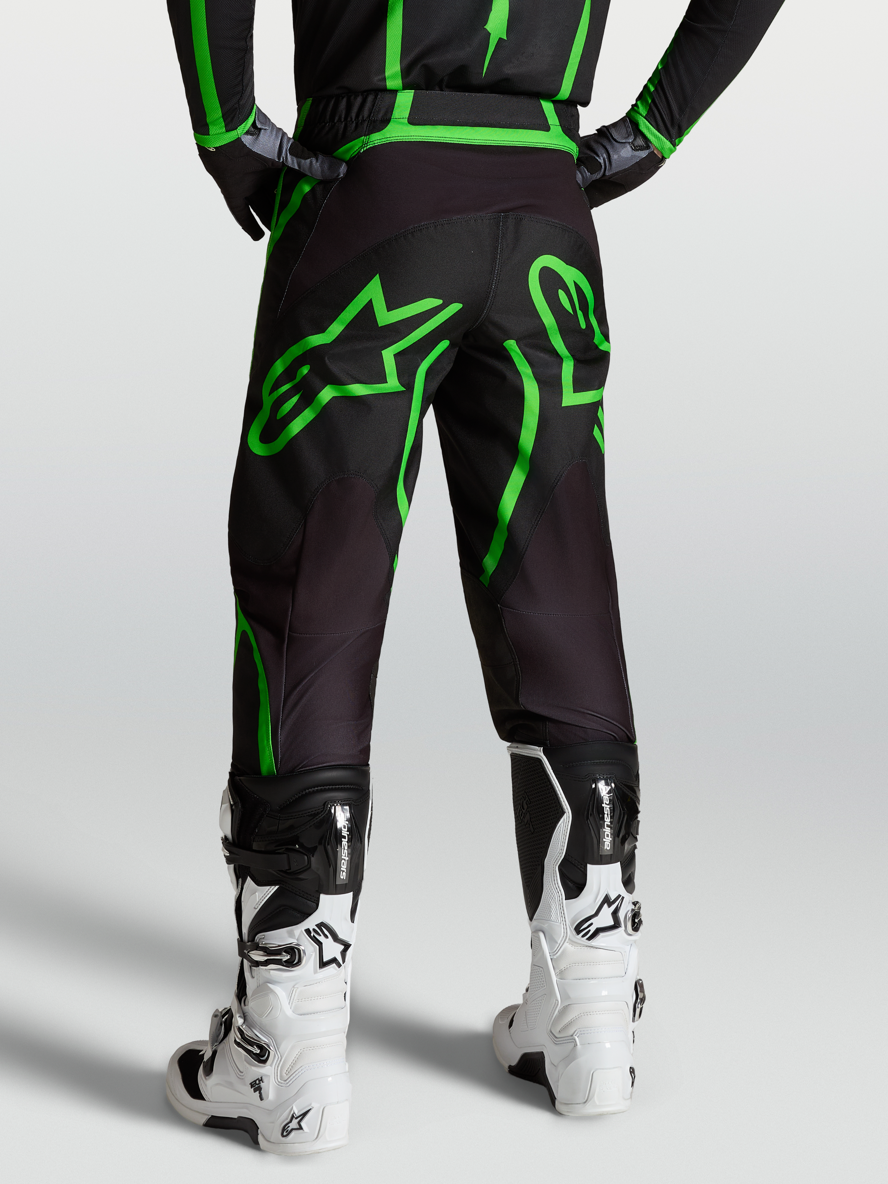 Alpinestars Fluid Apex V2 Pants, Men's Motocross and Off-Road Pants, Black and Green Fluo, Rear View on Model with White Boots.