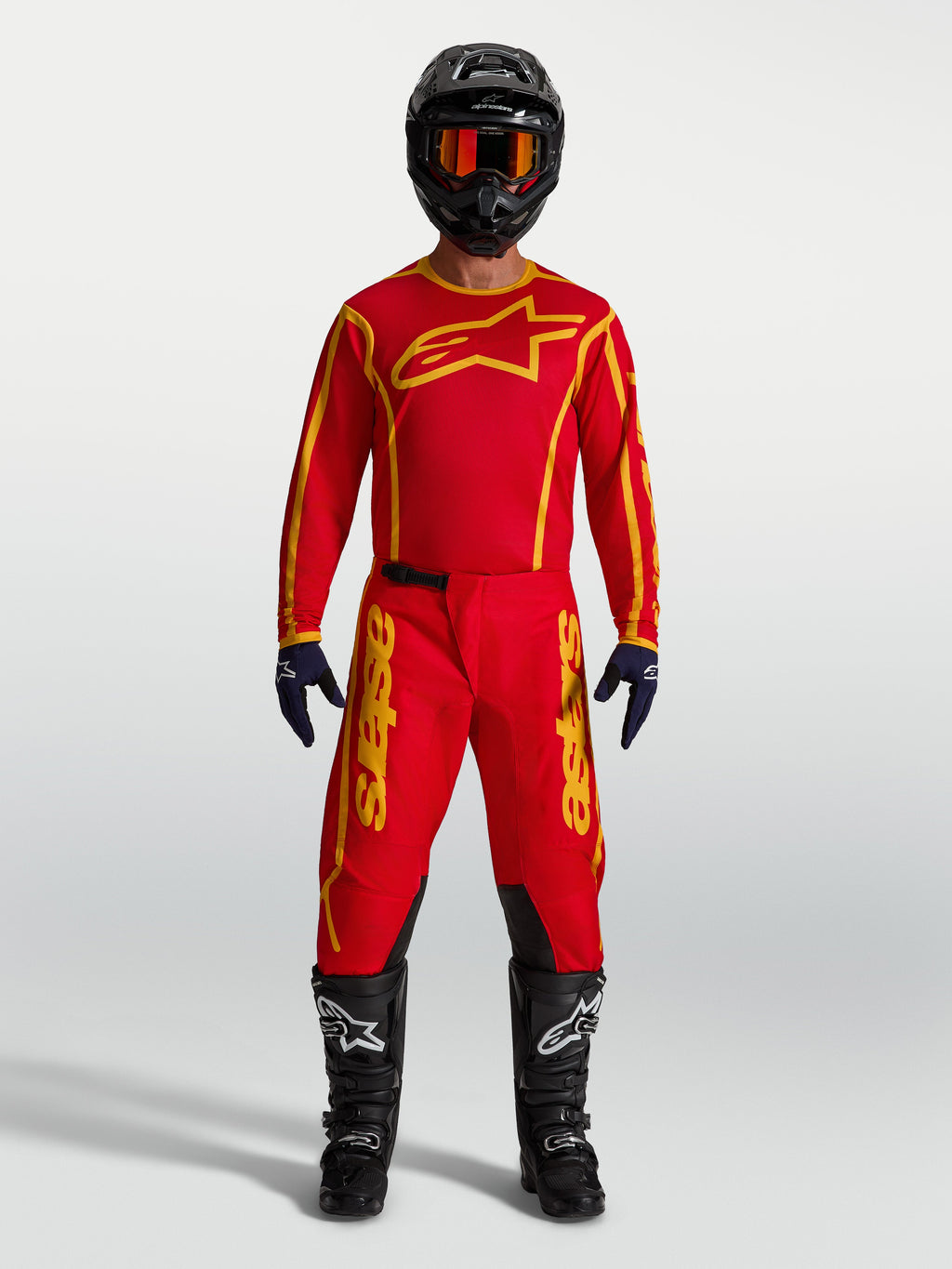 Alpinestars Fluid Apex V2 Jersey AND Fluid Apex V2 Gear Set, Men's Motocross Racing Apparel, Fire Red and Gold, moisture-wicking textile construction, shown on model with full riding kit.