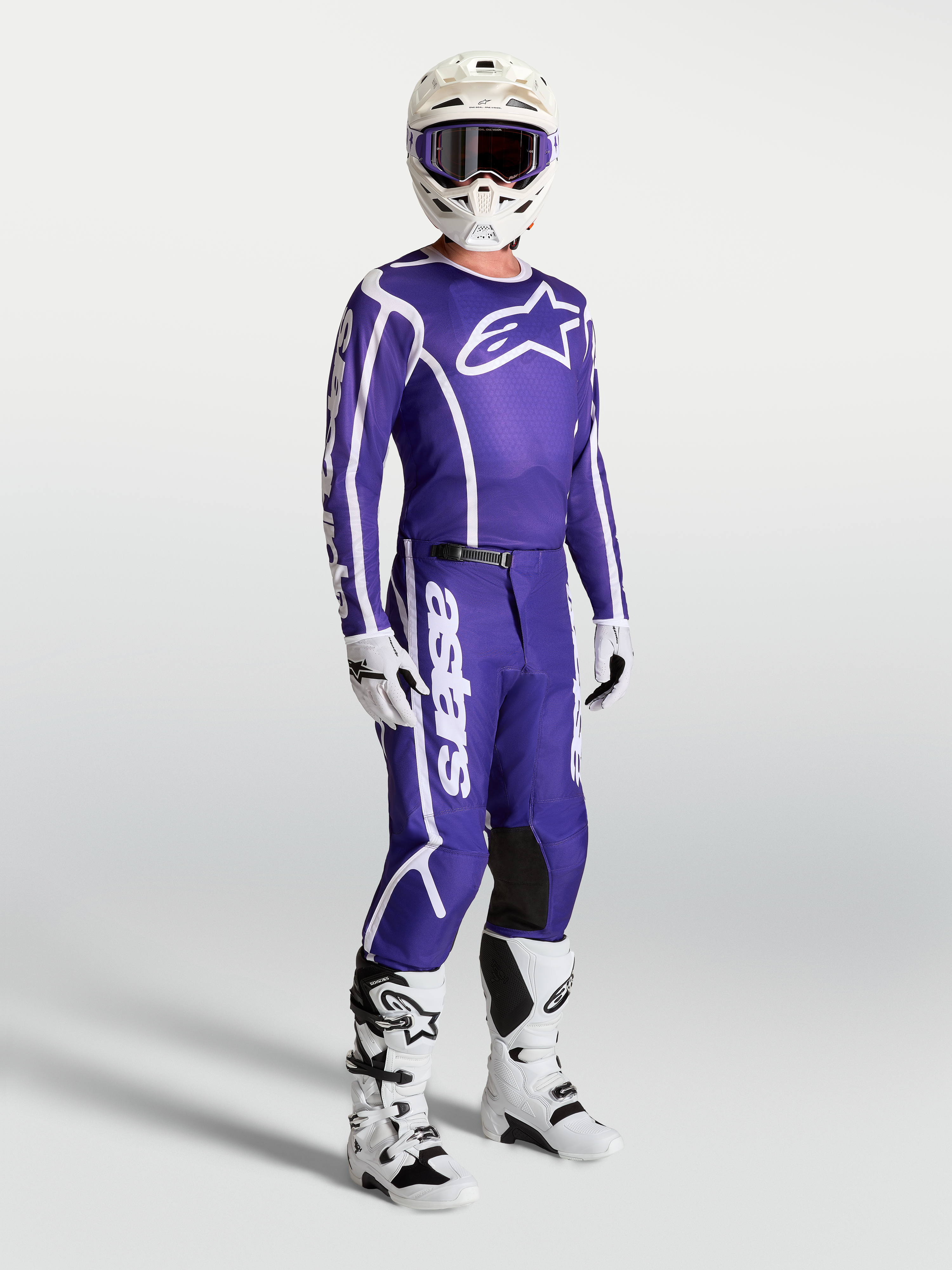 Alpinestars Fluid Apex V2 Jersey and matching pants, Deep Blue and White motocross gear set on-model with white boots and helmet.