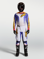 Alpinestars Fluid Drag motocross gear set in lilac, blue, and gold, featuring a matching jersey and pants.