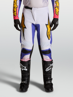 Alpinestars Fluid Drag Pants, Motocross Racing Pants for Men, Light Lilac and Iris Blue with Gold graphic star accents.