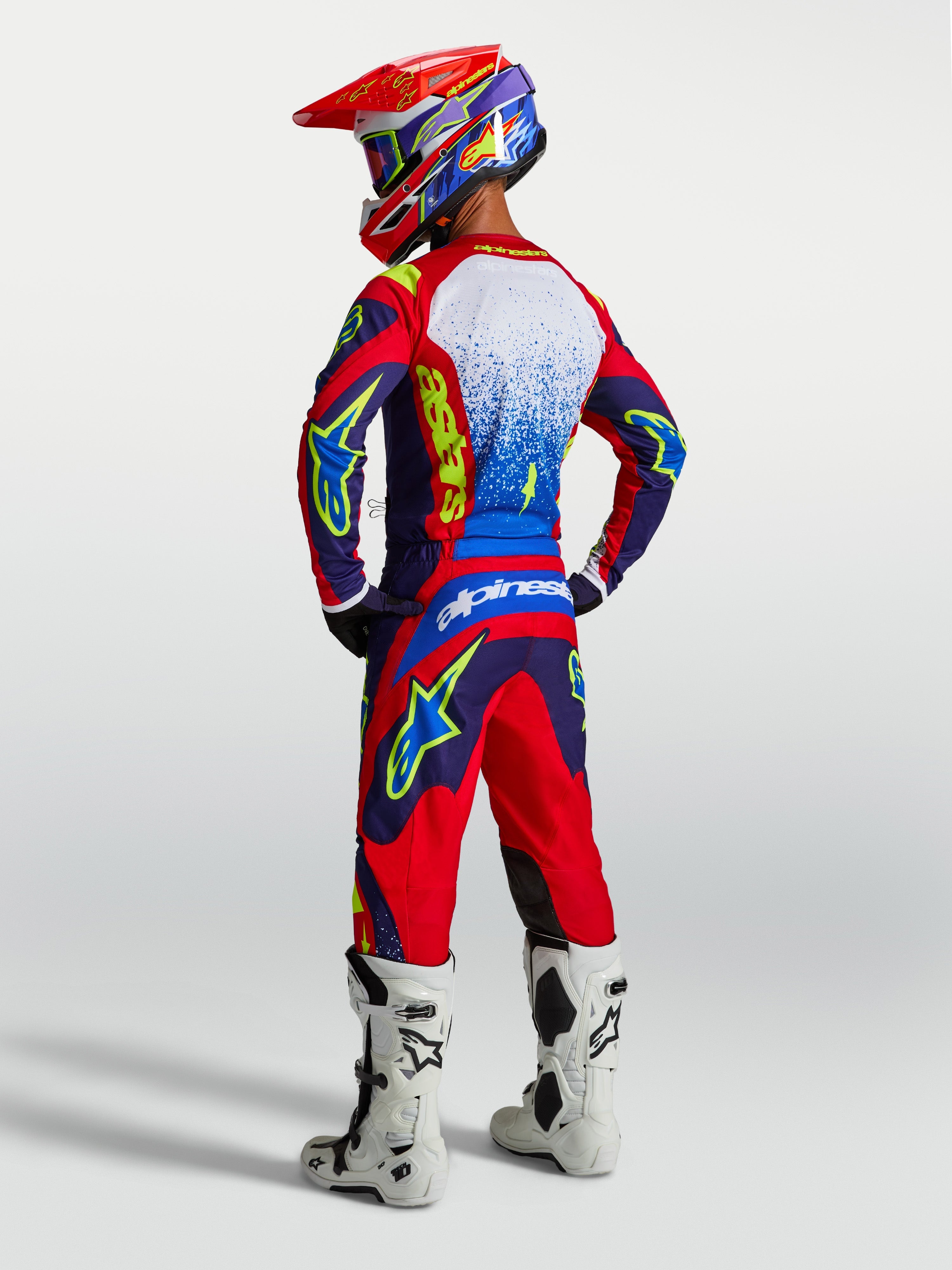 Alpinestars Fluid Drag Jersey, Blue and Red Motocross Top, Men's on-model rear view with matching gear and white boots.