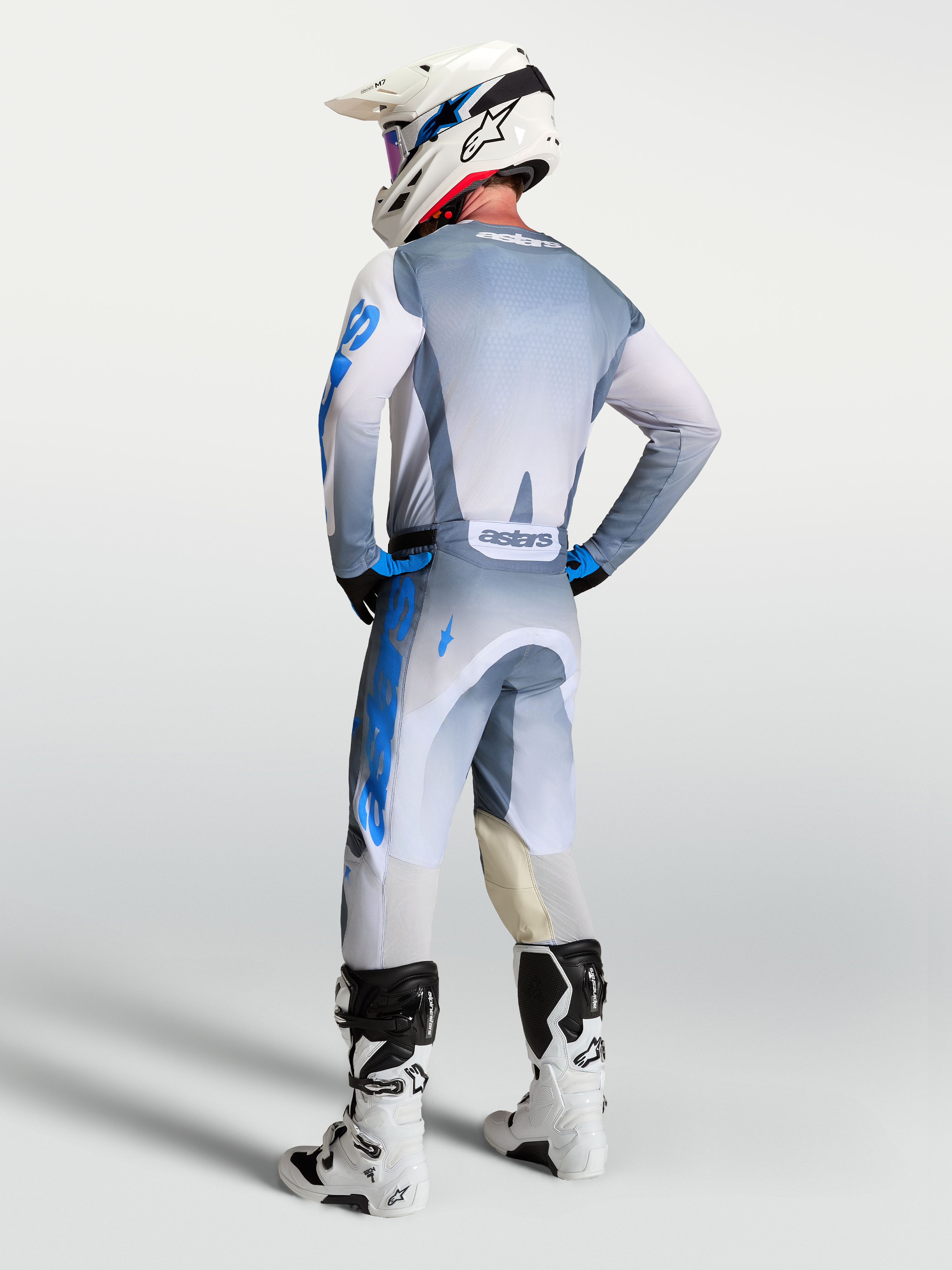 Alpinestars 2027 Racer Amber Jersey, Men's Motocross Gear, Ash Gray and UCLA Blue, rear view on rider with matching pants.