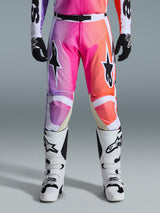 Alpinestars 2026 Racer Air Portl Pants, Motocross Pants, vibrant purple pink and orange gradient, featuring bold star logos on the thighs, worn with white racing boots and black gloves, designed for high-performance off-road riding.