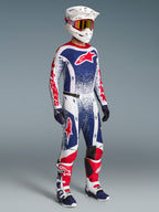 Alpinestars Limited Edition Techstar Unity men's motocross gear set in red, white, and blue with racing boots and helmet.