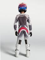 Alpinestars 2027 Youth Supertech Swan Jersey and Gear Set, gray and white motocross gear with red accents, rear view.