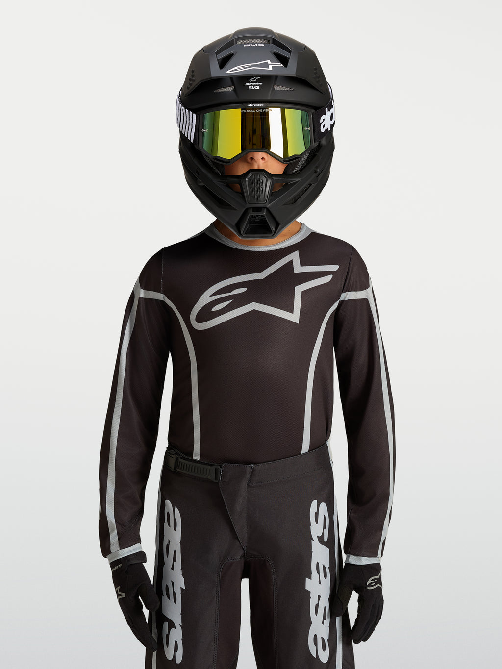 Alpinestars Youth Fluid Apex V2 Jersey, Black and Silver motocross gear, ergonomic athletic fit with moisture-wicking polyfabric.