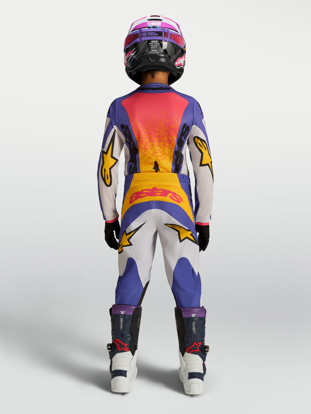 2027 Alpinestars Youth Fluid Drag Jersey and matching pants in blue and gold, youth motocross racing gear shown from the rear.
