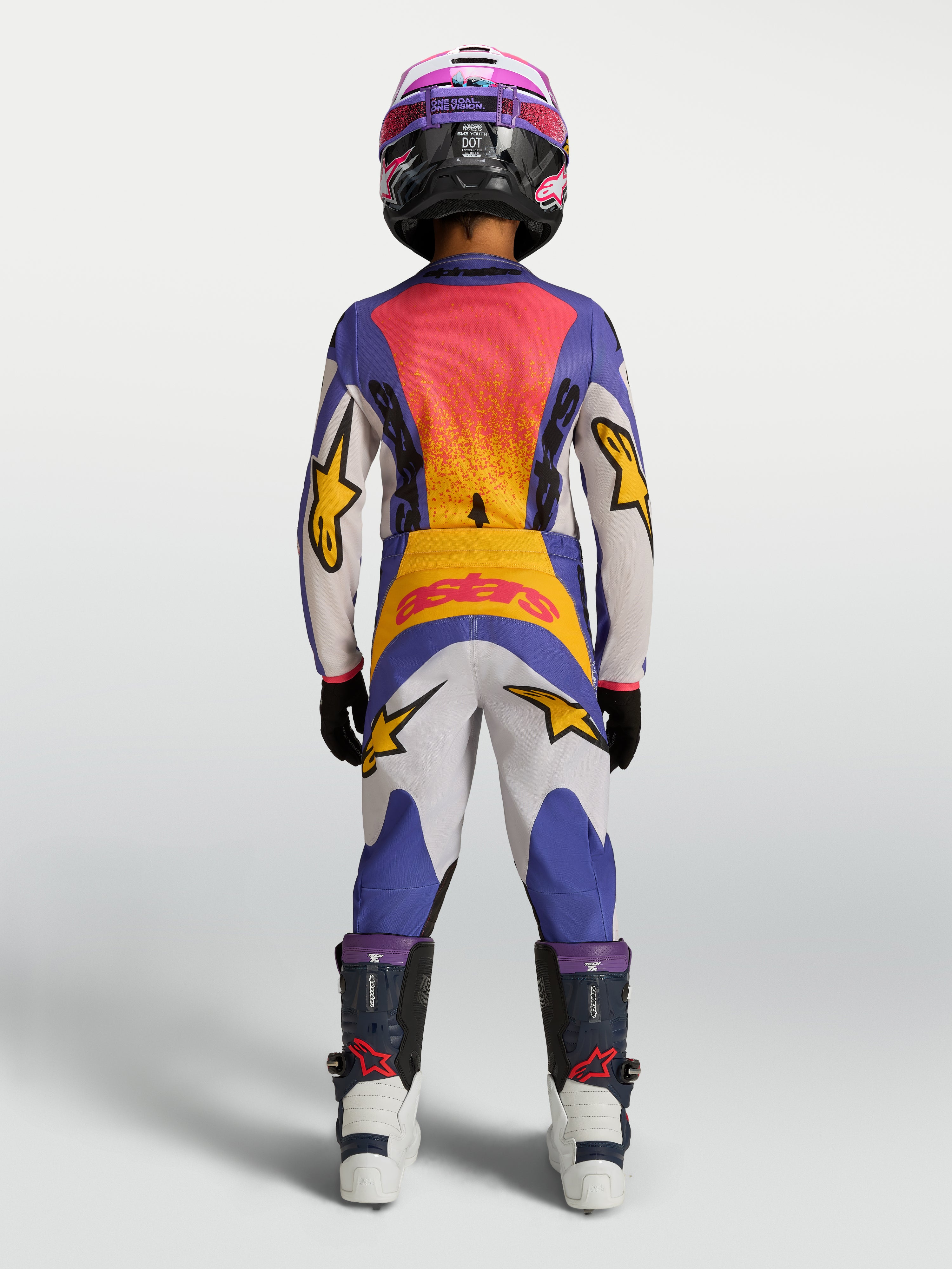 2027 Alpinestars Youth Fluid Drag Jersey and matching pants in blue and gold, youth motocross racing gear shown from the rear.