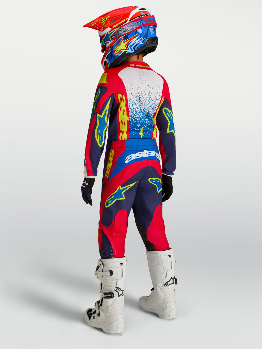 Alpinestars 2027 Youth Fluid Drag Gear Set, Blue Navy and Fire Red youth motocross outfit, rear view with white boots.