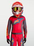 Alpinestars 2027 Youth Fluid Hunt Jersey, youth motocross gear, Fire Red and Graystone, on-model with racing helmet.