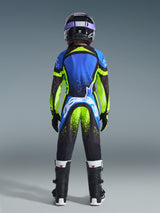 Youth motocross rider from behind wearing complete racing gear, Blue and Neon Yellow Supertech Nomur Jersey, matching pants with white branding on the seat, black helmet with purple goggles, black boots, coordinated outfit for off-road racing