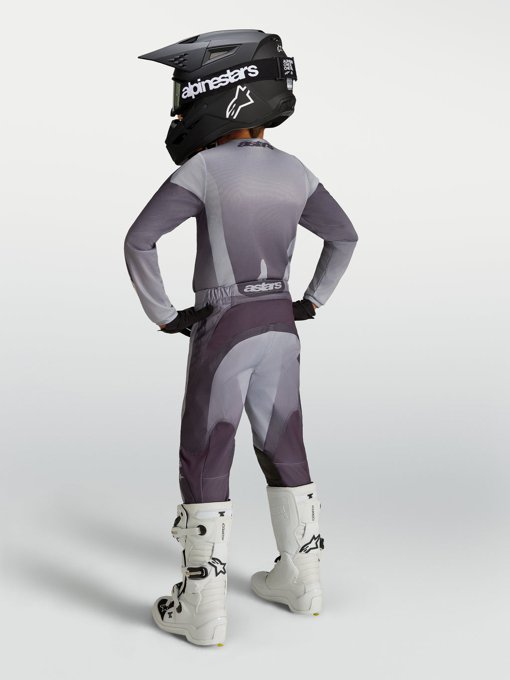 Alpinestars 2027 Youth Fluid Amber Gear Set, gray and purple youth motocross outfit with helmet and white boots.