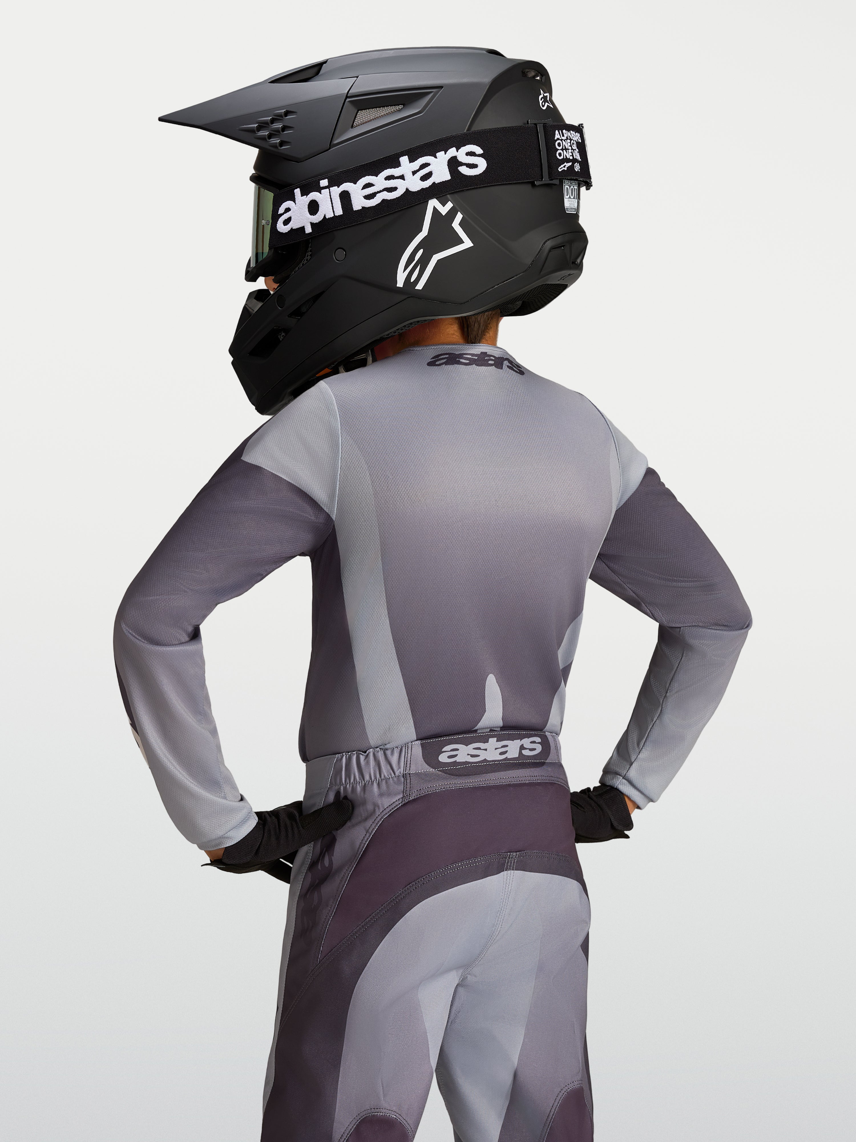 Alpinestars Youth Fluid Amber Jersey, gray and sand moisture-wicking motocross jersey on a young rider, back view.