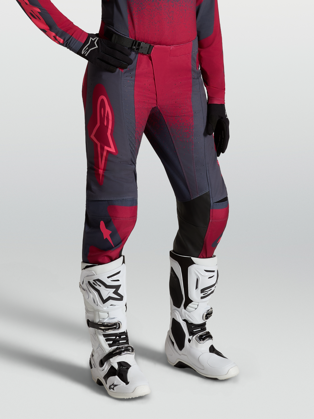 Alpinestars Stella Techstar Swan Pants, women's motocross gear in gray and crimson red, worn with Tech 10 white boots.