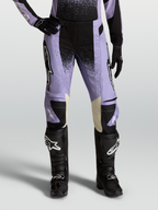 Stella Techstar Swan Pants, women's motocross racing pants in Light Violet and Black with cream leather accents, paired with black off-road boots.