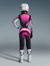 Female motocross rider from the back wearing the Alpinestars 2026 Stella Techstar Nomur Jersey in Black White and Fuchsia, matching motocross pants, white racing helmet, and white boots, featuring vibrant pink gradient designs and bold branding, coordinated off-road racing outfit