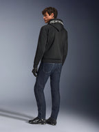 Alpinestars Chrome Superairflow Hoodie, Black, back view on male model, featuring white Alpinestars branding on the hood, worn with dark denim jeans and black gloves, urban motorcycle gear design