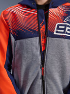 Alpinestars MM93 Chrome V2 Sport Hoodie, close-up of chest and collar, navy blue and gray melange tech fleece with red fluo graphics, featuring the white 93 logo and Alpinestars Protects branding on the inner zipper flap, Tech-Air Ready motorcycle riding apparel.