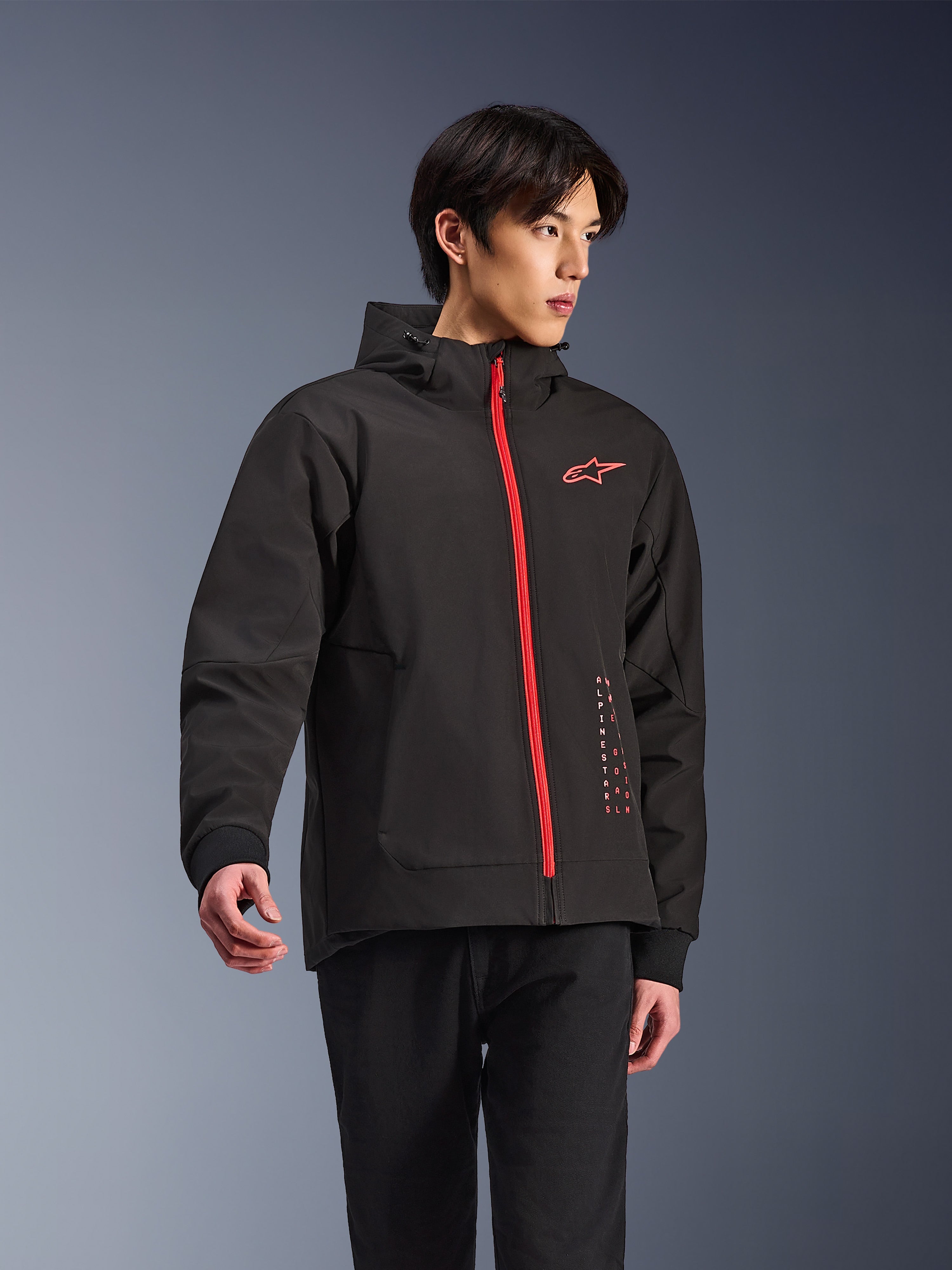 Alpinestars Radium Tech Hoodie, urban motorcycle jacket, Black with Bright Red zipper, featuring red Alpinestars logo on chest and red text on side, technical windproof shell with hood and ribbed cuffs, modern street style for riders