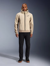 Alpinestars Radium Tech Hoodie in Mastic Aluminum, urban motorcycle hoodie worn by a male model with black pants and black boots, featuring a full-length black zipper, small chest logo, and athletic fit for city riding.