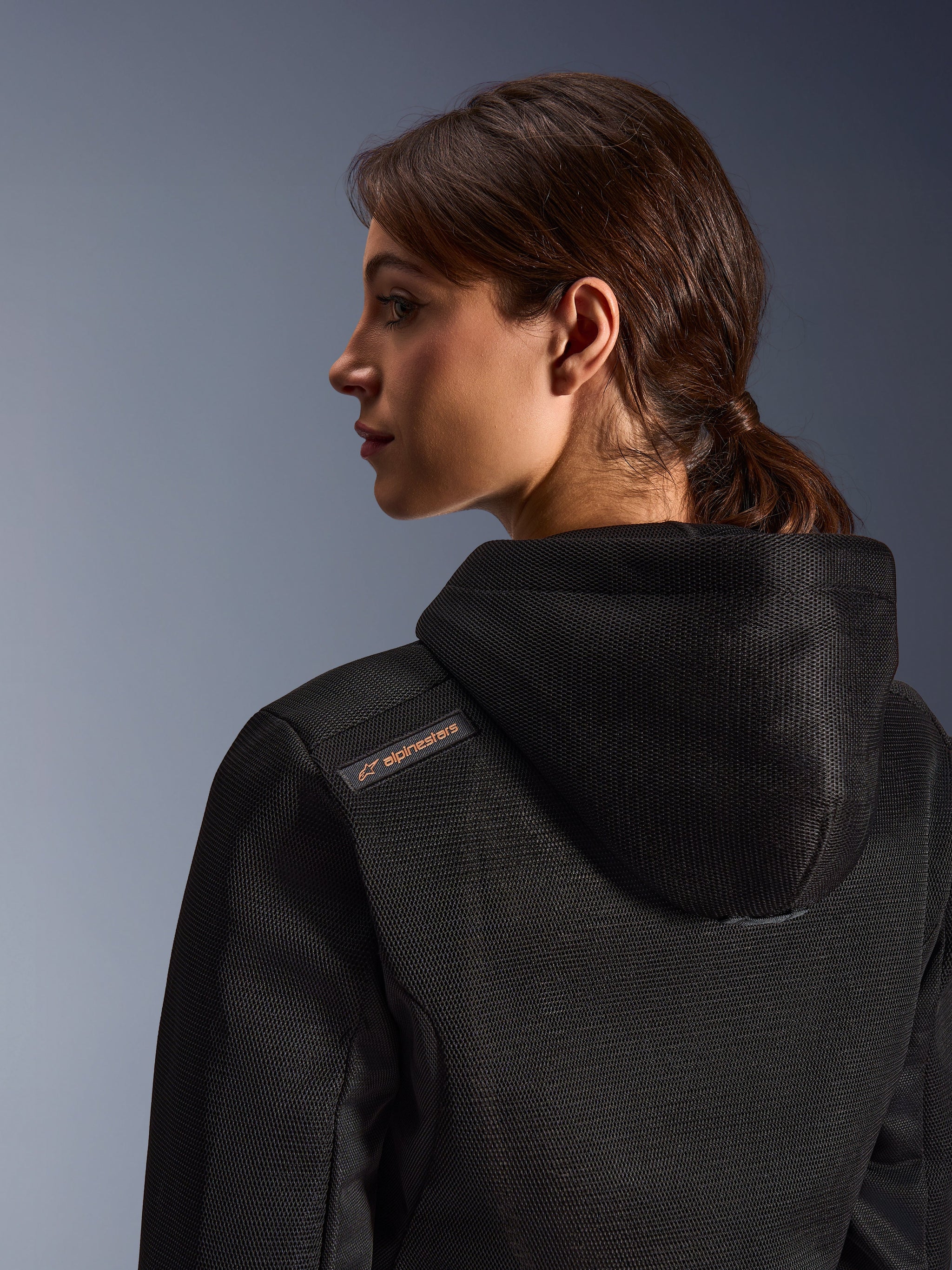 Alpinestars Stella Chrome Superairflow Hoodie, Women's Motorcycle Hoodie, Black with copper logo detail, close-up of 3D mesh construction on the back and shoulder, technical protective gear for urban sport riding