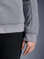 Close-up of the Alpinestars Stella Chrome V2 Sport Hoodie in Gray Heather, showing the ribbed hem and cuff details, tech fleece material, urban motorcycle gear for women