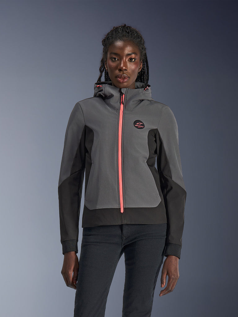 Alpinestars Stella Radium Tech Hoodie, Women's Motorcycle Hoodie, Deep Gray and Black with vibrant pink zipper and hood drawstrings, worn by a model, sporty urban design with Alpinestars chest logo