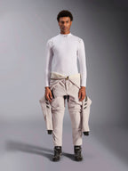 Alpinestars ZX Evo V3 Top, Long Sleeve, White, auto racing base layer worn with a light-colored racing suit tied around the waist and black racing boots, featuring a mock neck with logo and shoulder branding, professional flame-resistant motorsport underwear