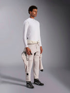 Alpinestars ZX Evo V3 Long Sleeve Top, White flame-resistant auto racing base layer, worn by a model with a racing suit tied around the waist, lightweight tech layer with mock neck and logo detail.