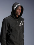 Alpinestars Chrome V2 Sport Hoodie, Black, urban riding hoodie worn by model with hood up, white star logo on chest and white stars branding on the hood, tech fleece construction, casual motorcycle streetwear