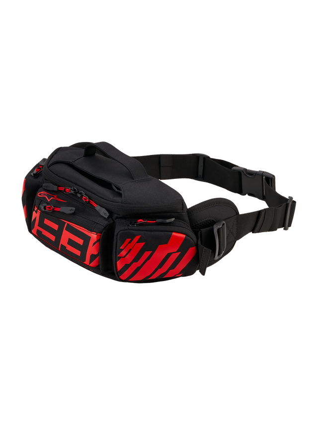Alpinestars MM93 Waist Bag, Motorcycle Hip Pack, Black with Red Fluo and Bright Red, featuring stylized red 93 logo on front, multiple zippered storage compartments with red pulls, adjustable black waist strap with buckle, durable textile construction