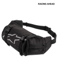 Alpinestars Tech Tool Pack, Black, durable motorcycle tool waist bag, featuring grey Alpinestars star logo, adjustable compression straps with plastic buckles, and zippered side compartments for enduro and off-road use