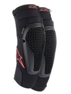 Alpinestars Bionic Flex Knee Protectors, Black and Red, pair of motocross knee guards featuring perforated Nucleon Flex Technology shields, red Astars logos, and elasticated straps on a breathable black mesh sleeve.