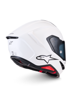 Alpinestars Supertech R7 Solid Helmet, white glossy full-face motorcycle racing helmet, side-rear profile view showcasing aerodynamic carbon composite shell, black A-star logo, and ECE 22.06 certification details
