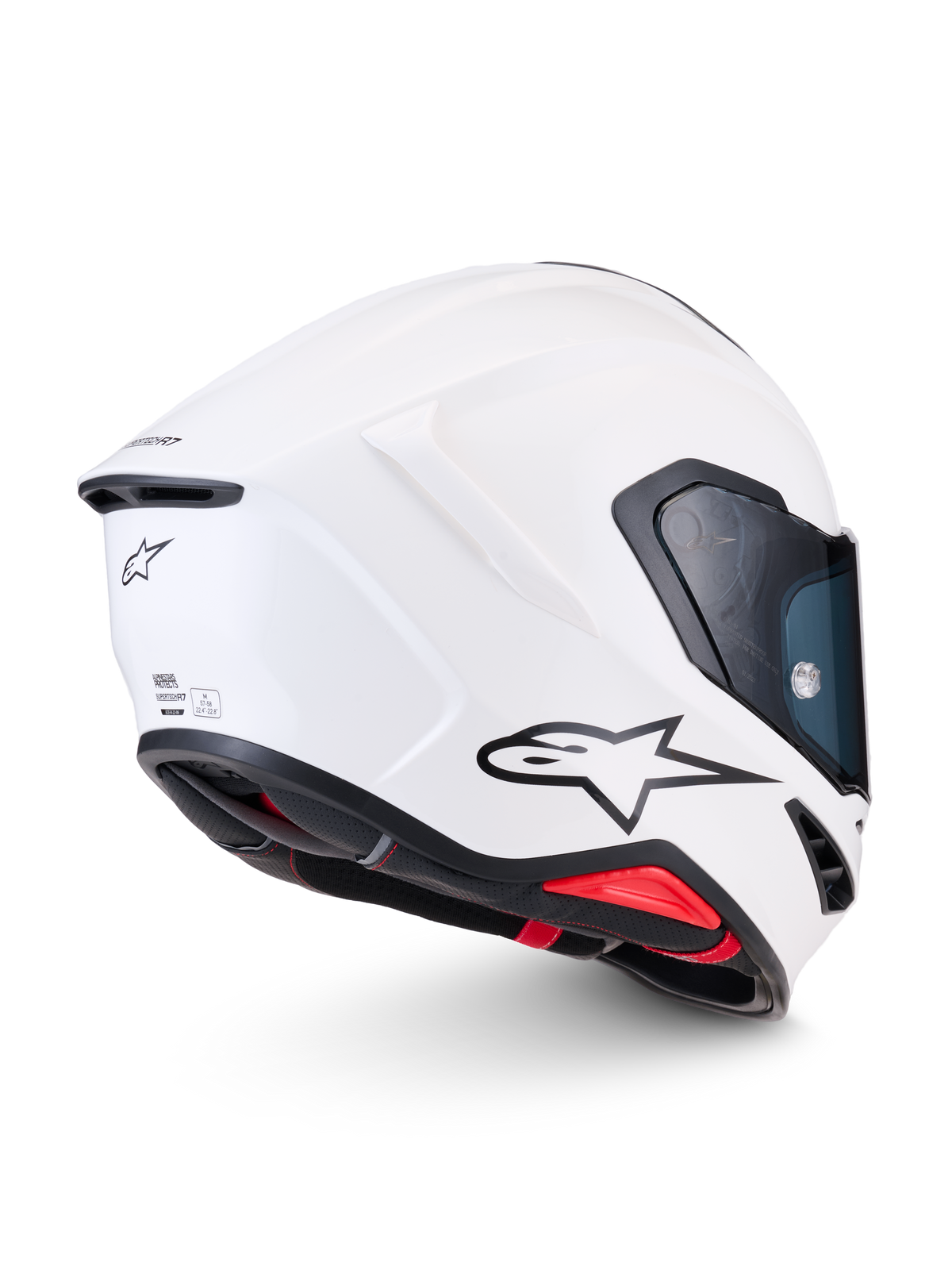 Alpinestars Supertech R7 Solid Helmet, white glossy full-face motorcycle racing helmet, side-rear profile view showcasing aerodynamic carbon composite shell, black A-star logo, and ECE 22.06 certification details