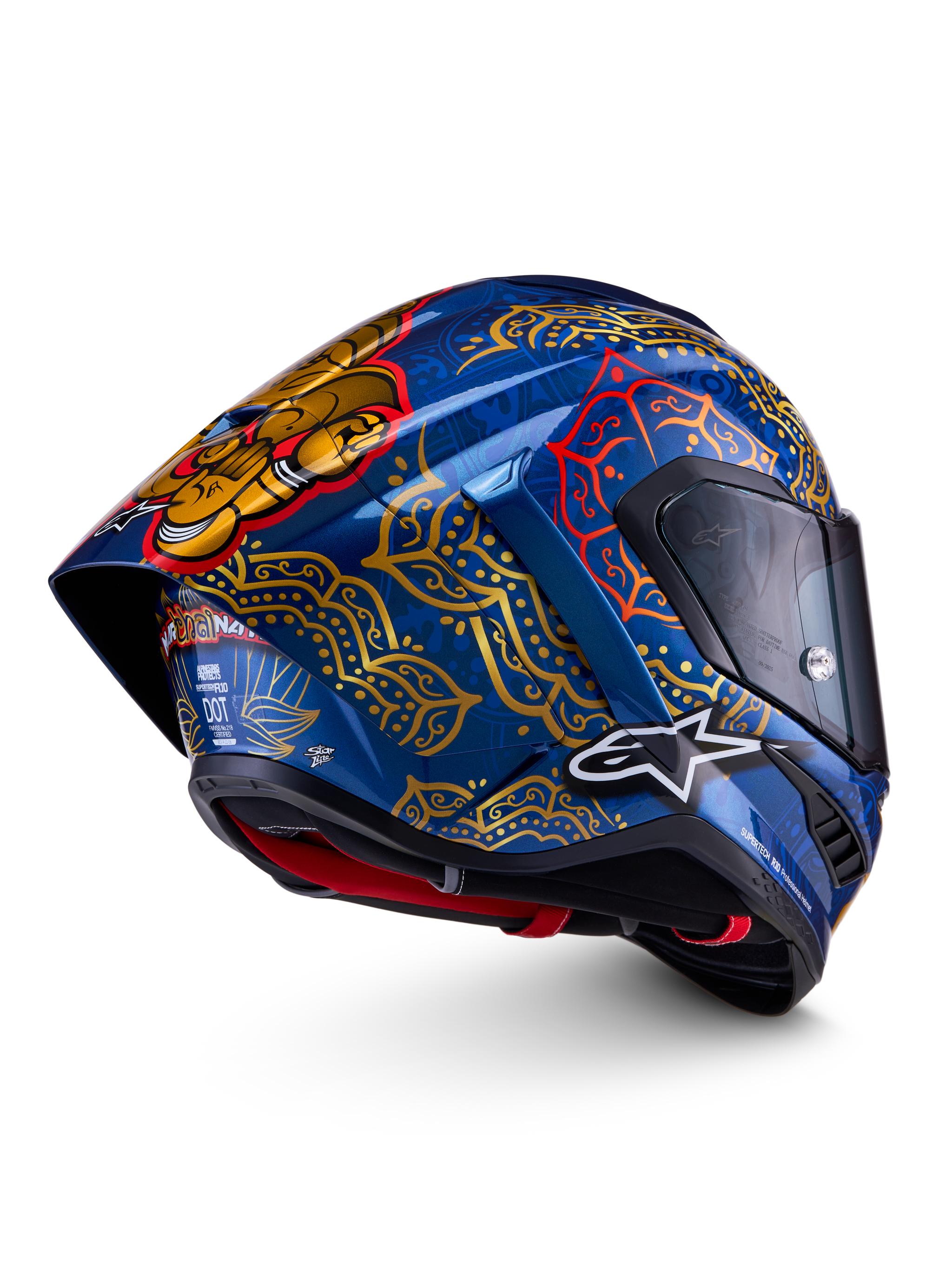 Alpinestars Supertech R10 Martinator Thai Helmet in glossy blue with gold mandala patterns and a rear spoiler.